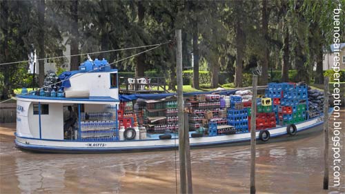 Supply Boat crossing the Arroyo Rama Negra, a branch of the Parana Delta in Tigre