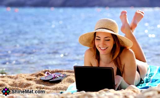 Girl working on-laptop in sea beach shinemat
