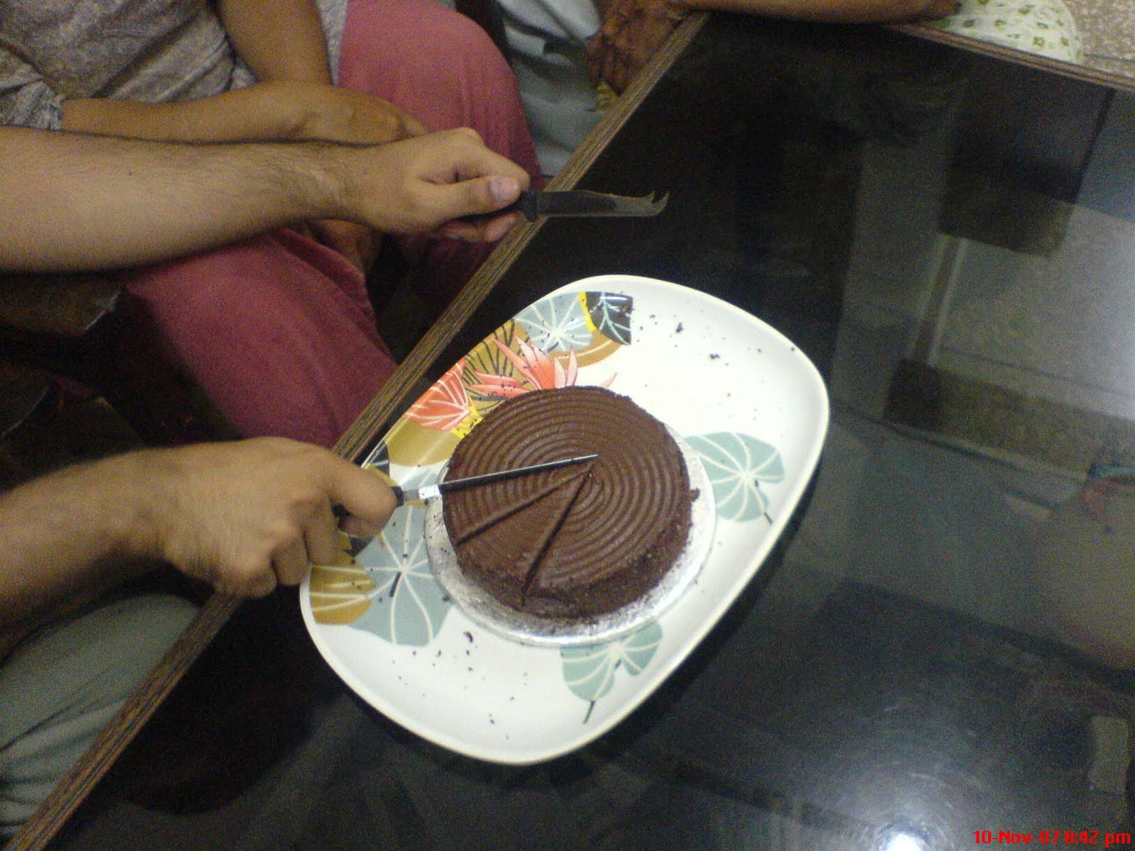 cool boy birthday cake Simple chocolate cake with rounded design being cut by birthday boy.
