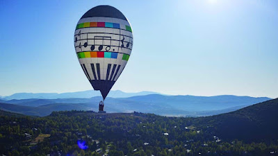 hot air balloon floats over Park Meadows