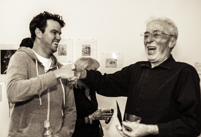 Theo Wujcik shaking hands with a fan at On a Clear Day exhibition at Tempus