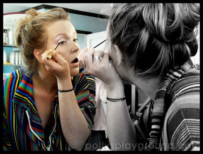 applying makeup in mirror