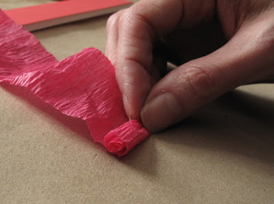 rolling crepe paper streamer into flowers