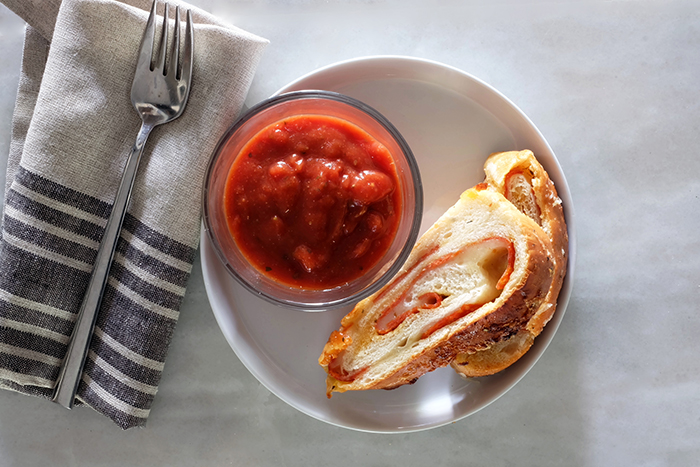 pepperoni bread plated with sauce