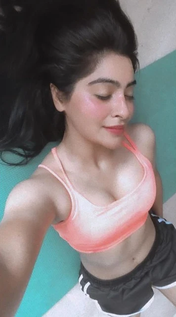 Yukti Kapoor in Gym wearing orange top and black short