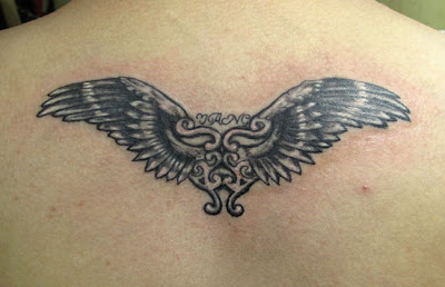 heart-wing tattoo on the back