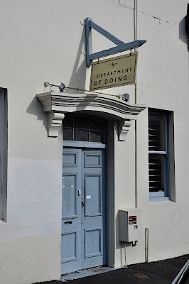 Door sign above the doorway to the Department of Doing