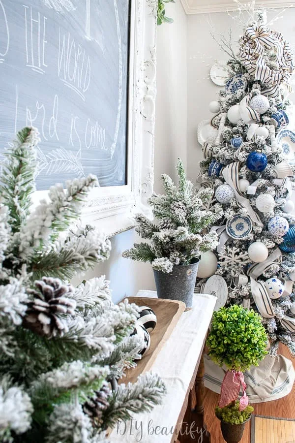 blue and white flocked Christmas tree decorated with antique transferware plates, tea cups and white ironstone