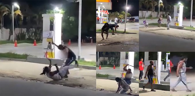 VIDEO: Medios internacionales difunden salvaje pelea a machetazos por una mujer en gasolinera de SPM RD donde uno de los peleadores recogió una mano cortada