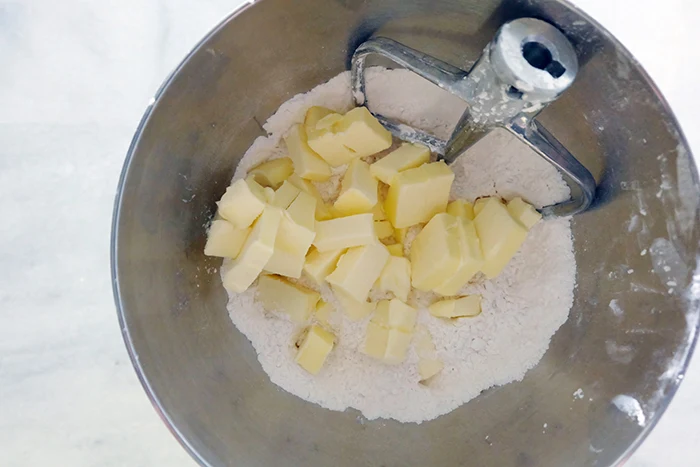 adding butter to dry ingredients