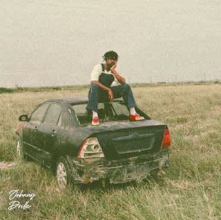 Cover Image Of Jonny Drille's New Single: He is sitting on an old Toyota Camry in the middle of a deserted field