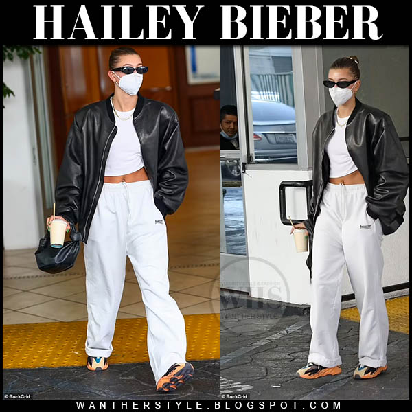 Hailey Bieber in black leather jacket and white sweatpants
