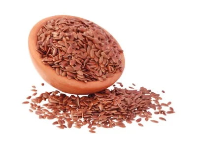 Flax seeds with pottery over white background