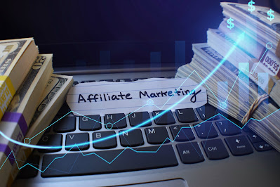 Affiliate marketing with bundles of money stacked on a computer.
