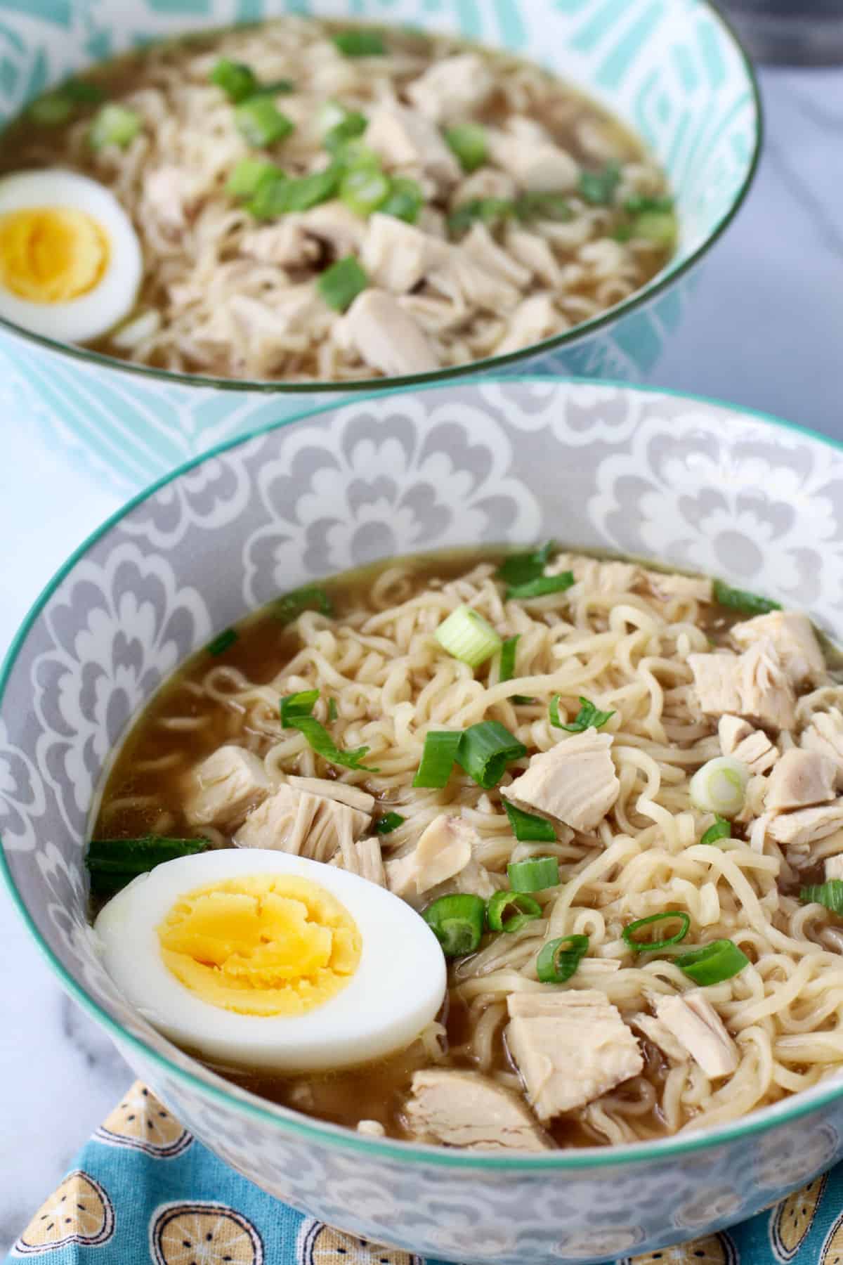 Rotisserie Chicken Ramen in two bowls with noodles.