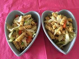 two heart shaped bowls with pasta