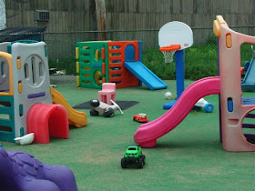garden toys in an outdoor space with astroturf 