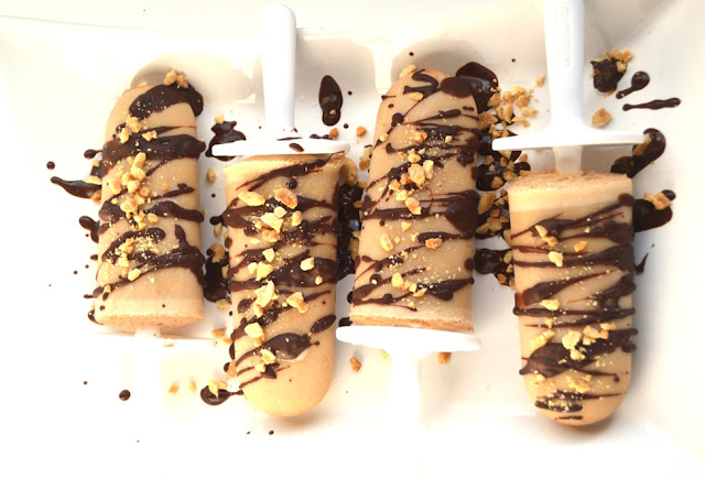 These Chocolate Peanut Butter Popsicles are  topped with drizzled chocolate and peanuts and are simple to make with only 6 ingredients! www.nutritionistreviews.com