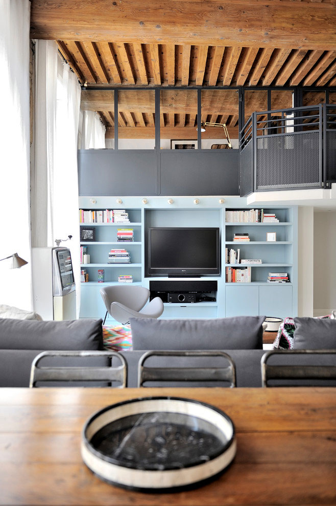 French loft with wooden beams, mid century modern furniture, white floors, colorful details