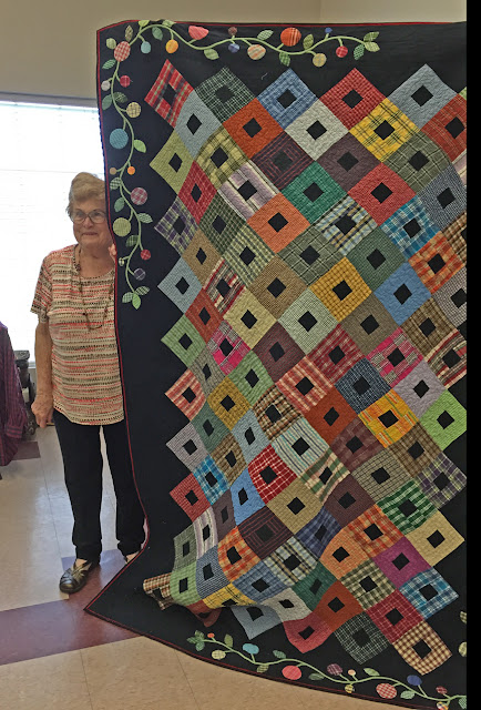 Sue Welton, a Beaumont, TX quilter with her thrift store shirt quilt 