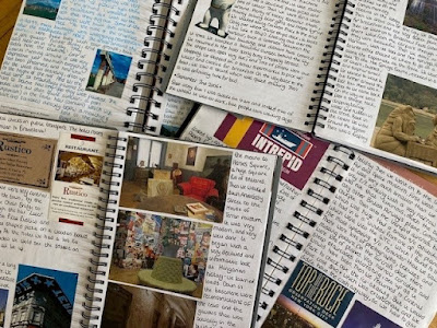 Pile of travel journals with ephemera