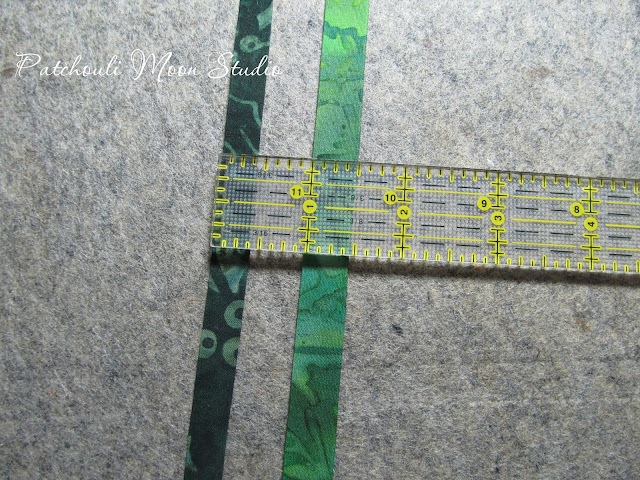 fabric strip showing how fabric stems for flowers are made in 2 sizes