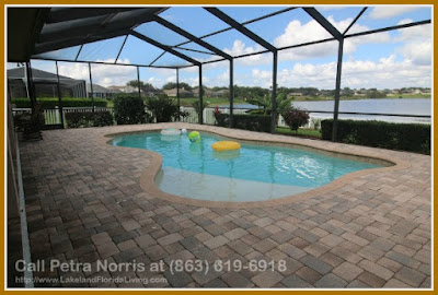 Call your friends and invite them for an afternoon swim in the enclosed heated pool of this Winter Haven FL lakefront home for sale in Hart Lake Hills. 