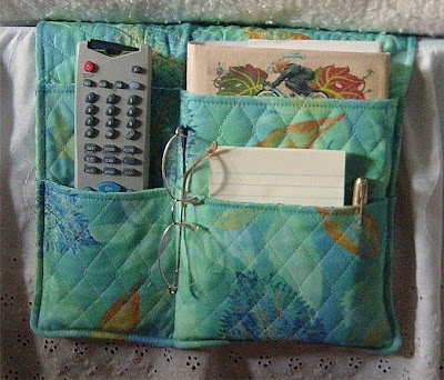 bed caddy with remote, notepad and pen, eyeglasses, and more