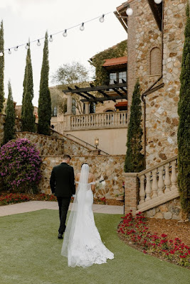 bride and groom walking at bella collina