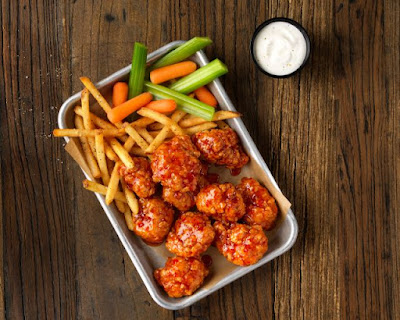 A tray of Buffalo Wild Wing's boneless wings and fries.