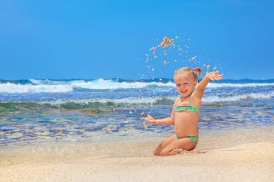 Waves-Beach-Little-girlbaby-enjoying-touch-of-sand