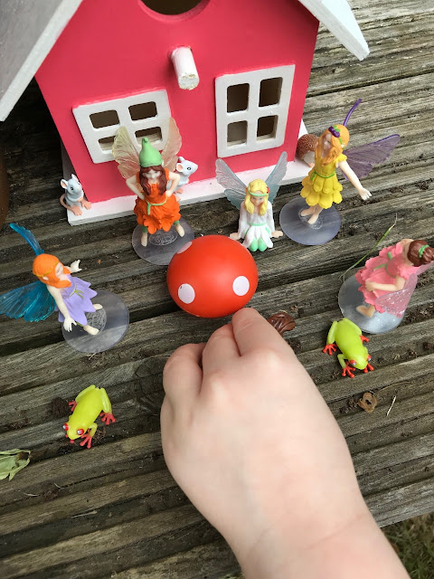 Childs hands playing with the animals and fairies