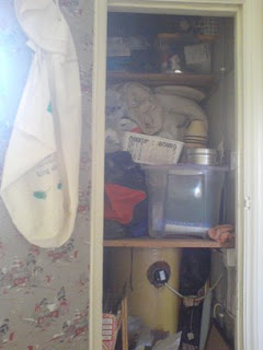 view of the junk in the airing cupboard