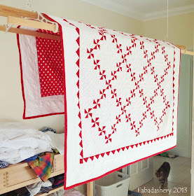 Red and White Pinwheel Quilt drying on the Sheila Maid
