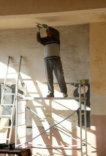 Scraping the ceiling of old paint