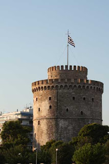 The Greek Flag Flys At The White Tower In Thessaloniki.