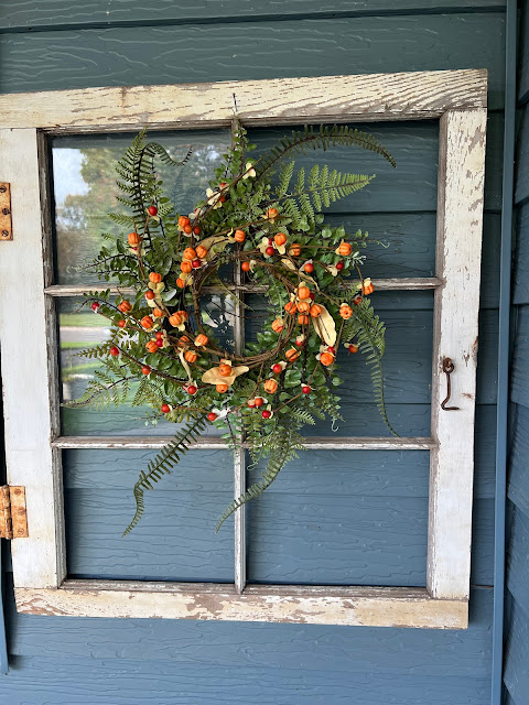 Photo of an old window with wreaths.