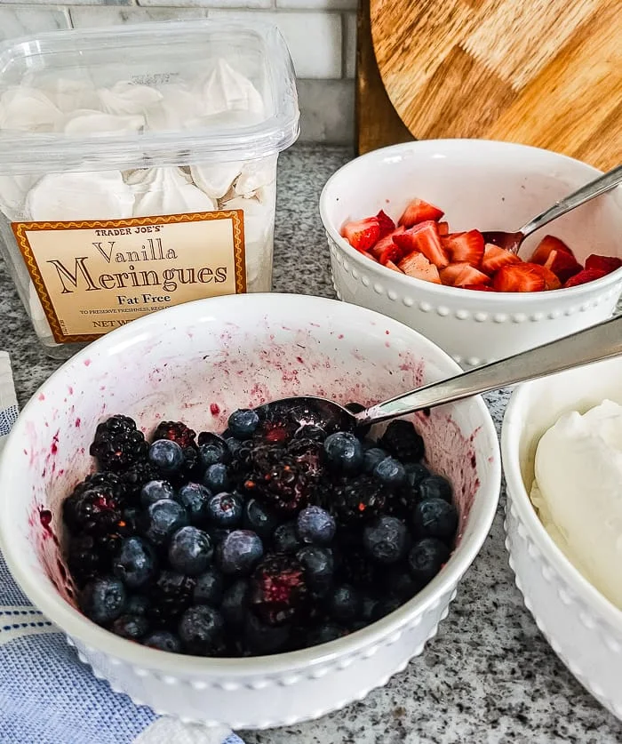 berries, whip cream, meringue cookies