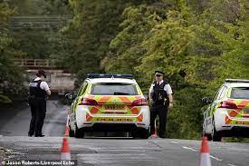 A black Mercedes slammed onto a flooded road in Liverpool, killing two people.