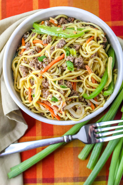 Ground Beef Chow Mein in a white bowl with a fork on the side.
