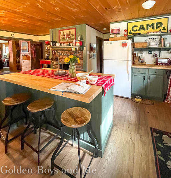 Cabin kitchen with fireplace and Benjamin Moore Backwoods paint - www.goldenboysandme.com