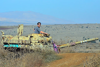 craig baumer posing with abandoned tank golan heights israel