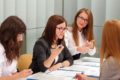 3 women are interviewing another