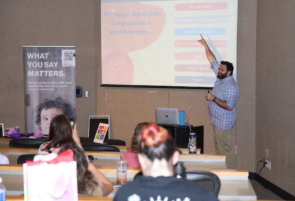 A man giving a powerpoint lecture to an audience