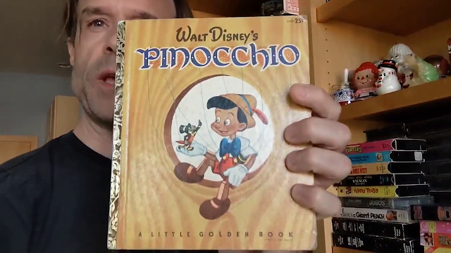 picture of man holding children's illustrated book