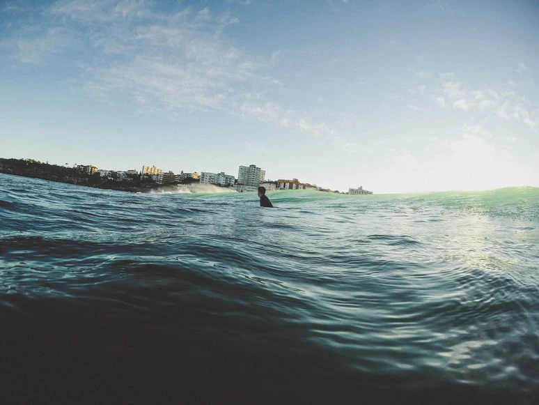 Surfista en Bondi Beach (Sídney, Australia), fotografía a través de Unsplash