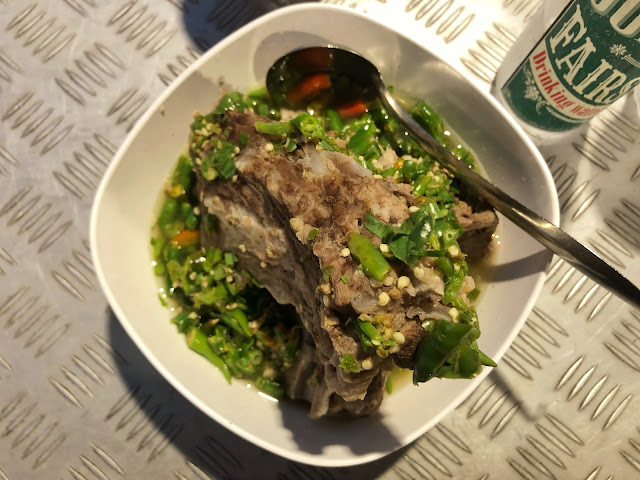 pork spine soup (ต้มแซ่บเล้ง) with chili, garlic, lime, and cilantro broth