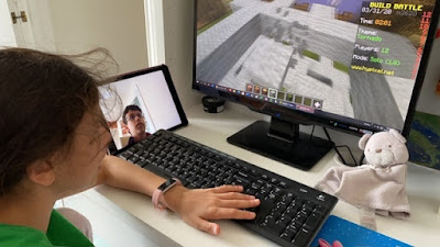 Children playing Minecraft on a screen