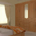 Kerala bedroom interior design with wooden wardrobe