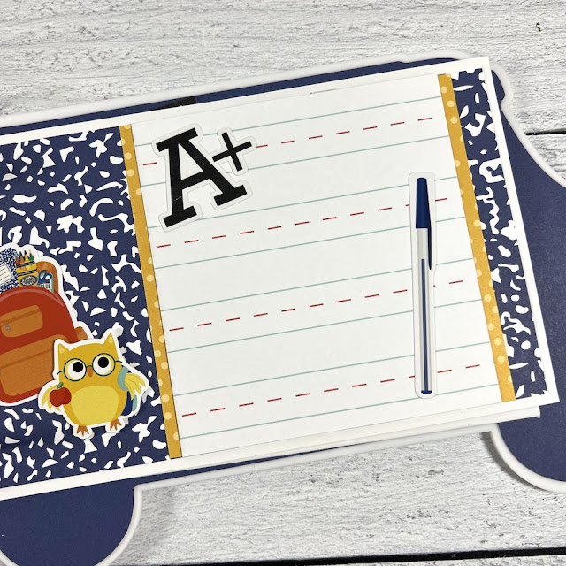 School scrapbook album page with an owl, a backpack, a pen, and lined school paper
